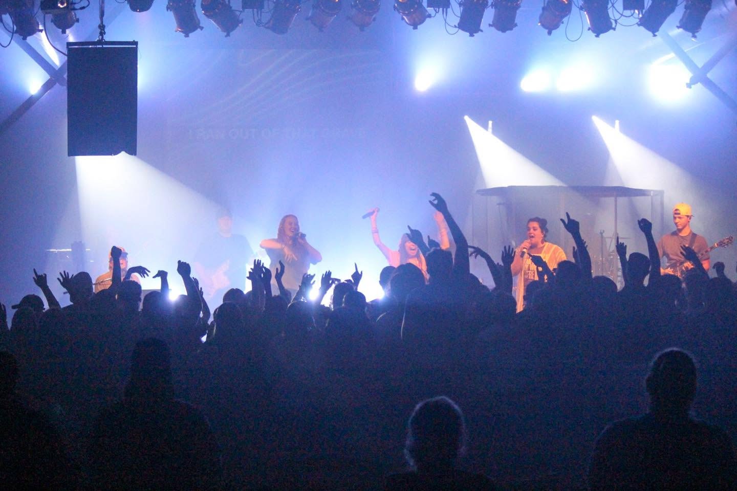 After Sunday leading worship under blue stage lights